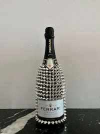 a bottle of ferrari champagne with spikes on it