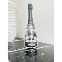 a bottle of champagne sitting on top of a marble table