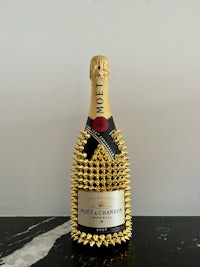 a bottle of champagne with spikes on it